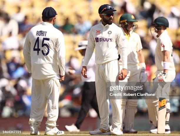 Rohit Sharma of India speaks with Virat Kohli during day one of the First Test match in the series between India and Australia at Vidarbha Cricket...