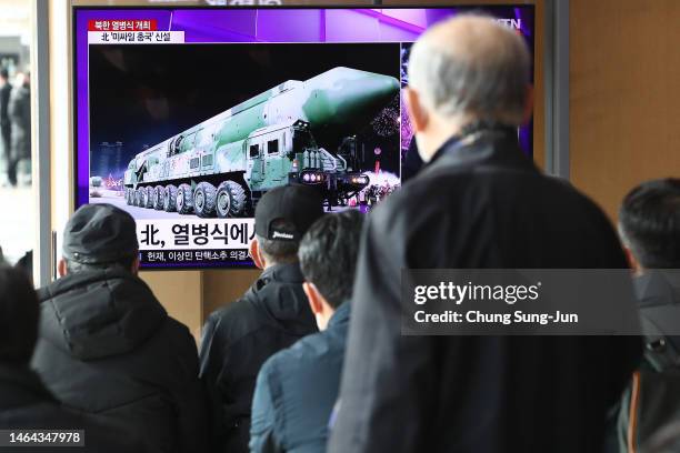 People watch a television show North Korea's 75th anniversary of the founding of the armed forces day military parade released by Korean Central News...