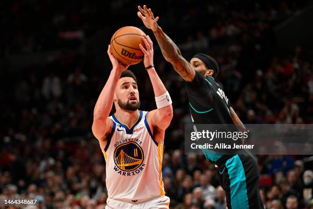 Klay Thompson of the Golden State Warriors shoots the ball against Gary Payton II of the Portland Trail Blazers during the third quarter at the Moda...