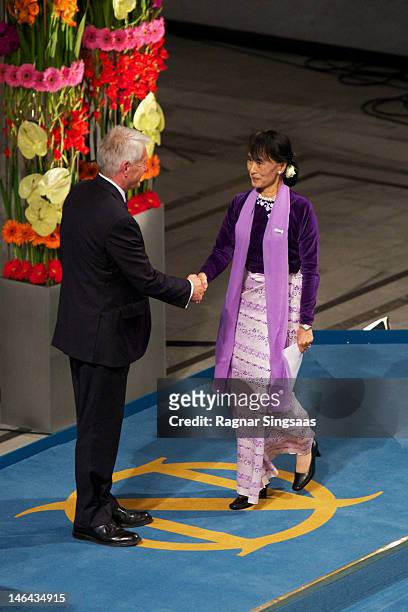Chair of the Nobel Committee Thorbjorn Jagland and Nobel Laureate Aung San Suu Kyi shake hands at the Nobel Peace Prize lecture at Oslo City Hall on...