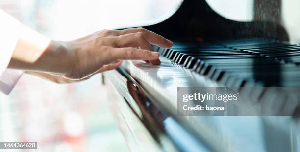 close up of woman's hand playing the piano - finger pic stock pictures, royalty-free photos & images