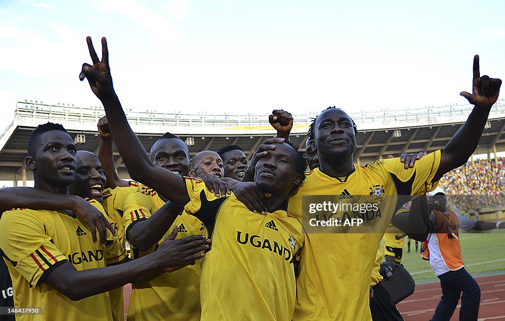 Walusimbi Godfrey (2-R) celebrates with