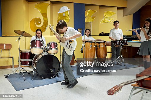 Elementary students playing instruments in music room Elementary students playing instruments in music room