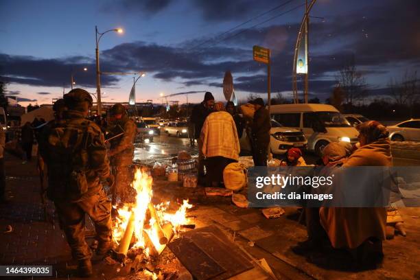 Earthquake survivors keep warm up by a fire on February 8, 2023 in Malatya, Türkiye. An earthquake with a magnitude of 7.8 occurred in the Pazarcık...