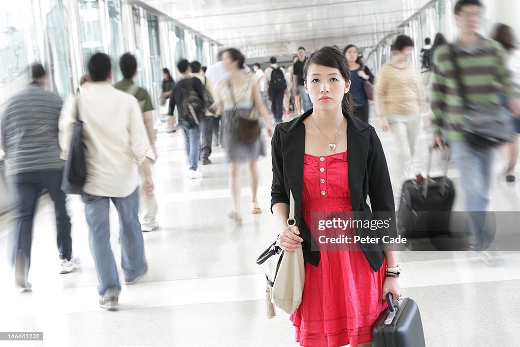 Woman stood alone in busy walkway