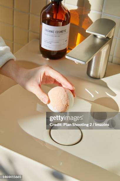 morning, bathroom sink, light, sunlight, bathroom, sunny day, human hand, facial cleanser, bath bomb - bath bomb stock pictures, royalty-free photos & images