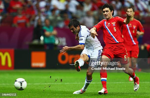 Giorgos Karagounis of Greece scores the opening goal under pressure from Yuriy Zhirkov of Russia during the UEFA EURO 2012 group A match between...