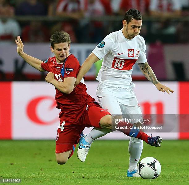 Vaclav Pilar of Czech Republic tackles Ludovic Obraniak of Poland during the UEFA EURO 2012 group A match between Czech Republic and Poland at The...