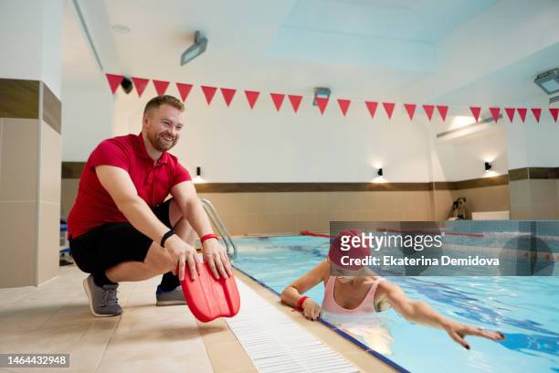 positive man and woman in swimming pool - swimming coach stock pictures, royalty-free photos & images