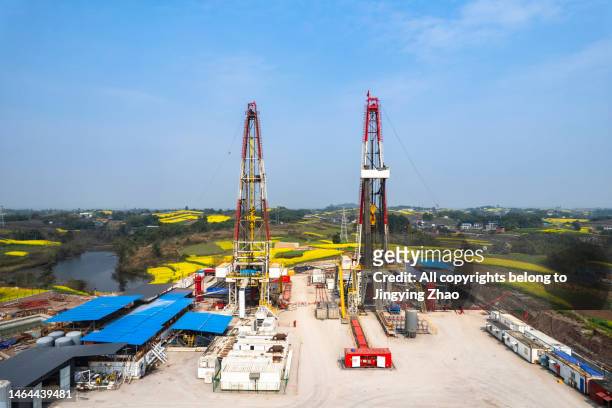 aerial photo of shale gas drilling scene in golden oilseed rape fields of southern sichuan in spring - drill stock pictures, royalty-free photos & images