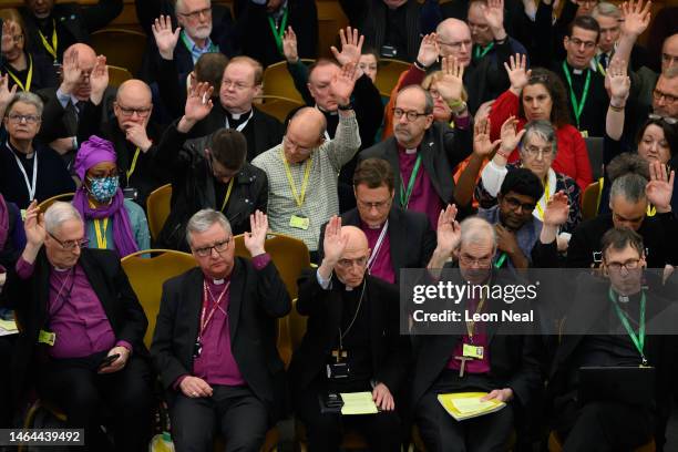 Members of the General Synod place their votes during a discussion on an amendment at The Church House on February 09, 2023 in London, England. The...