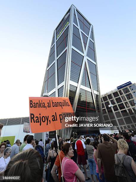 People holding a placard reading "Bankia to the bench trail. Rajoy unemployed" during a demonstration against bank fraud on June 16, 2012 in front of...