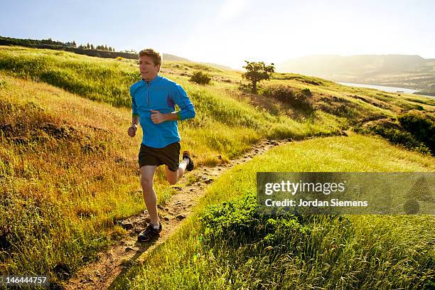 trail running for exercise. - laufen und gras und sport stock-fotos und bilder