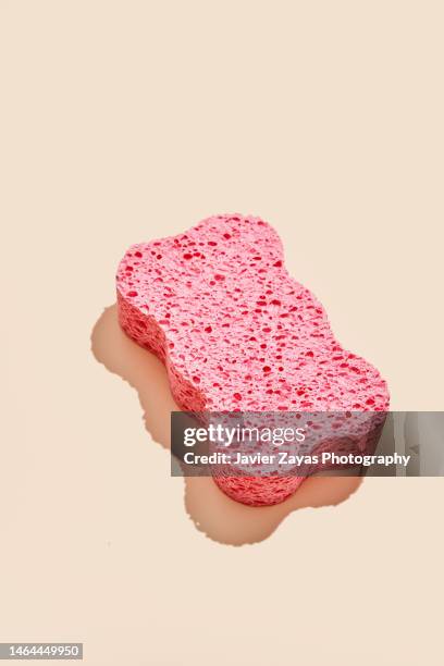 pink sponge on beige background - cleaning sponge stock pictures, royalty-free photos & images