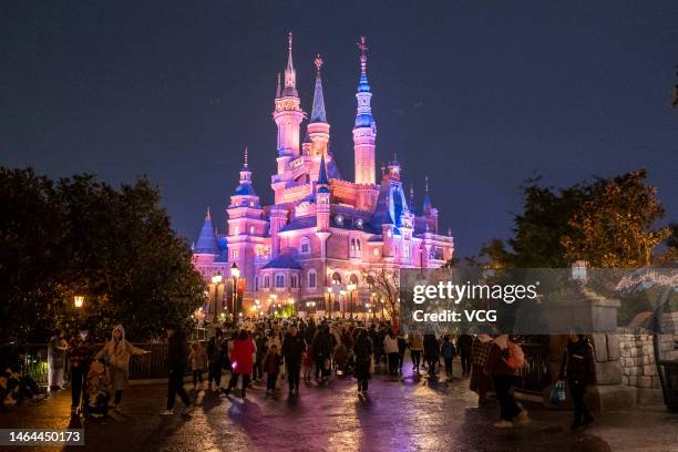 Tourists visit Shanghai Disney Resort on a rainy night on February 8, 2023 in Shanghai, China.