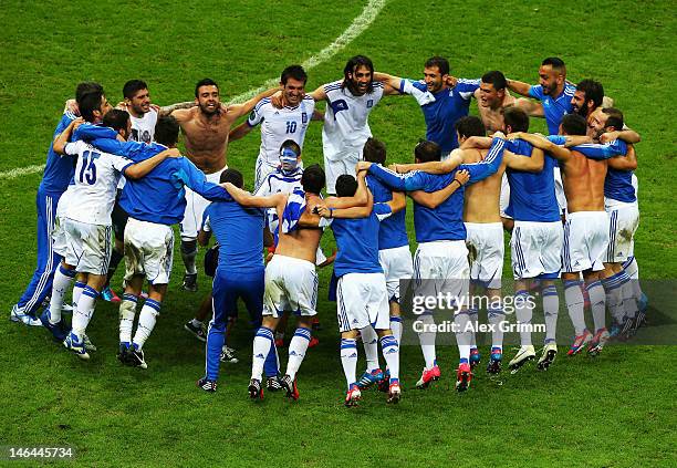 The Greece team celebrate victory and progress to the quarter finals with the son of Giorgos Samaras during the UEFA EURO 2012 group A match between...