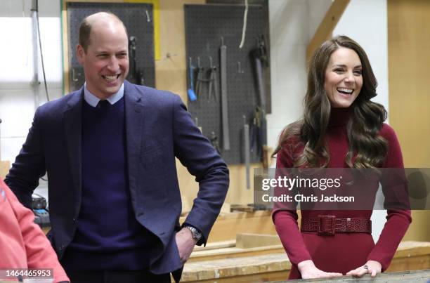 Prince William, Duke of Cornwall and Catherine, Duchess of Cornwall share a joke with local people working in the boat building workshop during their...