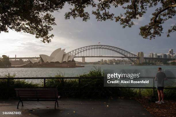 Person looks out at The Sydney Opera House and Harbour Bridge at Mrs Macquaries Point on February 09, 2023 in Sydney, Australia. On July 6, 2022 the...