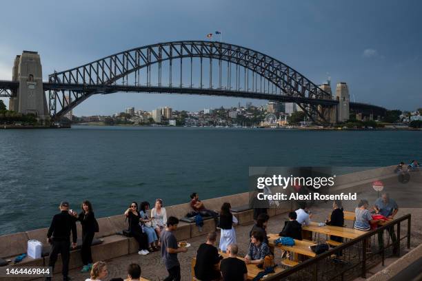 People sit at restaurants outside The Sydney Opera House with the Harbour Bridge in the background on February 09, 2023 in Sydney, Australia. On July...