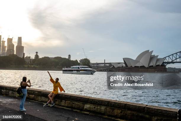 People take photos with The Sydney Opera House and Harbour Bridge at Mrs Macquaries Point on February 09, 2023 in Sydney, Australia. On July 6, 2022...