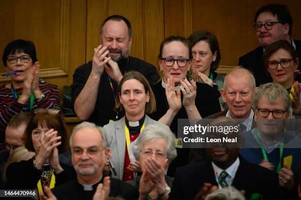 Members of the General Synod react after blessings for same-sex couples was approved in a vote by the General Synod at The Church House on February...