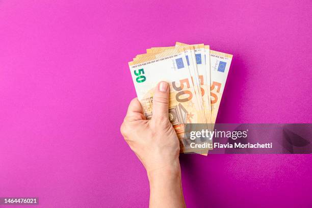 hand holding euro - euro stock-fotos und bilder