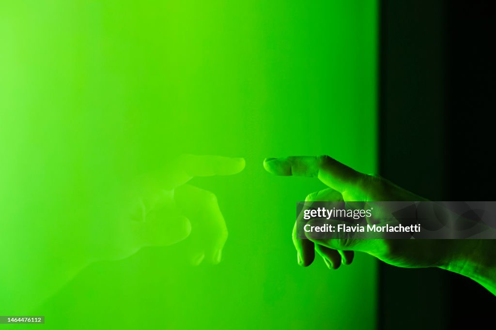 Hand touching green screen