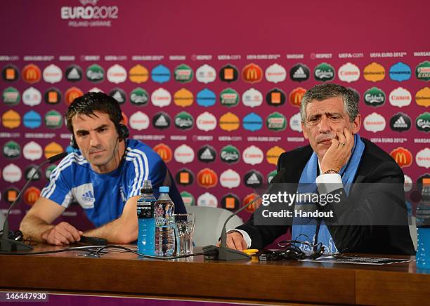 In this handout image provided by UEFA Coach Fernando Santos of Greece and Giorgos Karagounis talk to the media during a press conference after the...