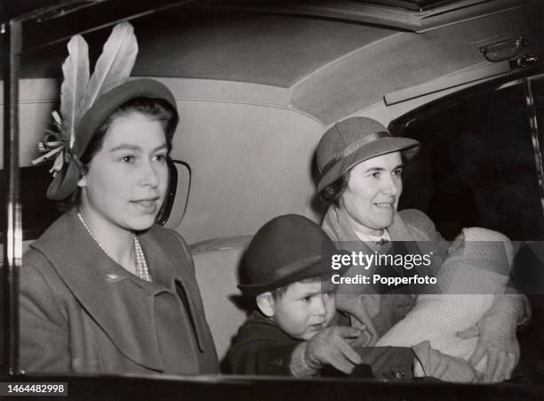 British Royals Princess Elizabeth and her son, Prince Charles of Edinburgh, with Royal nanny Helen Lightbody holding Princess Anne of Edinburgh, as...