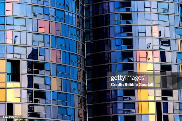 sunset reflected into the square windows of a cbd high-rise building. - repetition office stock pictures, royalty-free photos & images