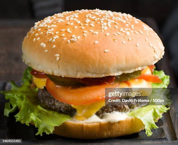 close-up of burger on table,purwakarta,indonesia - plain hamburger stock pictures, royalty-free photos & images