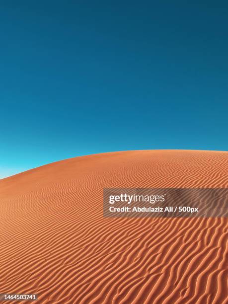 scenic view of desert against clear blue sky,saudi arabia - désert photos et images de collection