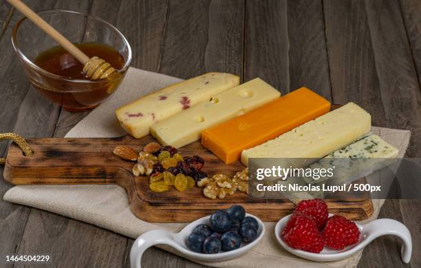 assorted cheese board with honey and nuts,roman,romania - hartkäse stock-fotos und bilder