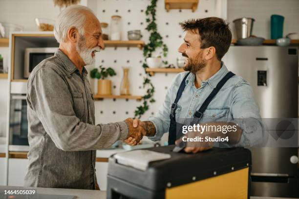 customer welcoming repairman - tradesman toolkit stock pictures, royalty-free photos & images
