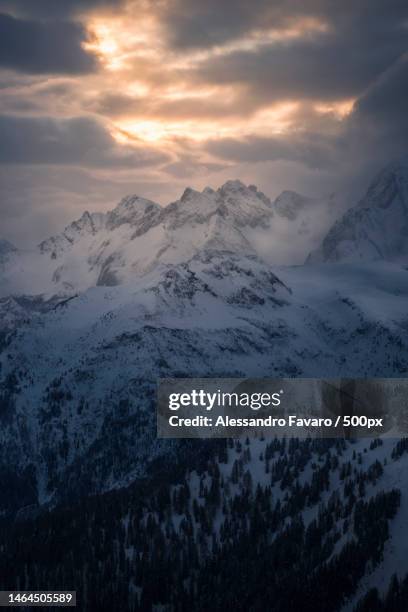 scenic view of snowcapped mountains against sky during sunset,passo giau,colle santa lucia,belluno,italy - colle santa lucia stock pictures, royalty-free photos & images