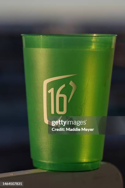 Commemorative plastic cup with a "16" logo is seen on the 16th hole during the first round of the WM Phoenix Open at TPC Scottsdale on February 09,...