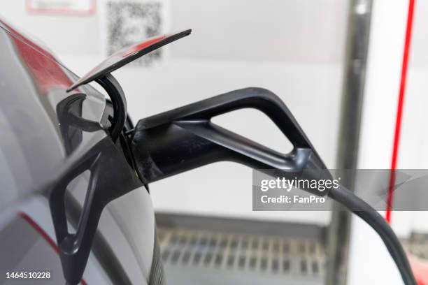 electric vehicle charging gun charging - gasoline pistol stock pictures, royalty-free photos & images