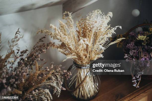 dried wheat and wildflowers in glass jars. - wilted stock pictures, royalty-free photos & images