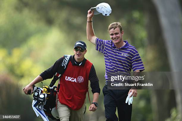 John Peterson of the United States celebrates a hole-in-one on the 13th hole with his caddie Gentry Mangun during the third round of the 112th U.S....