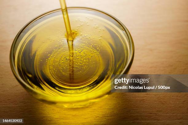 glass cup with extra virgin olive oil with bubbles,roman,romania - oil stock pictures, royalty-free photos & images