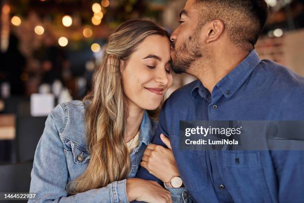couple, coffee shop and forehead kiss for love celebration, anniversary or congratulations for relationship diversity. man, woman or celebrate at restaurant for care, smile or happy memory together - couple dark background bildbanksfoton och bilder
