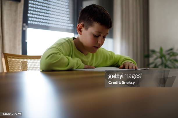 boy doing his school work or homework - dyslexia stock pictures, royalty-free photos & images