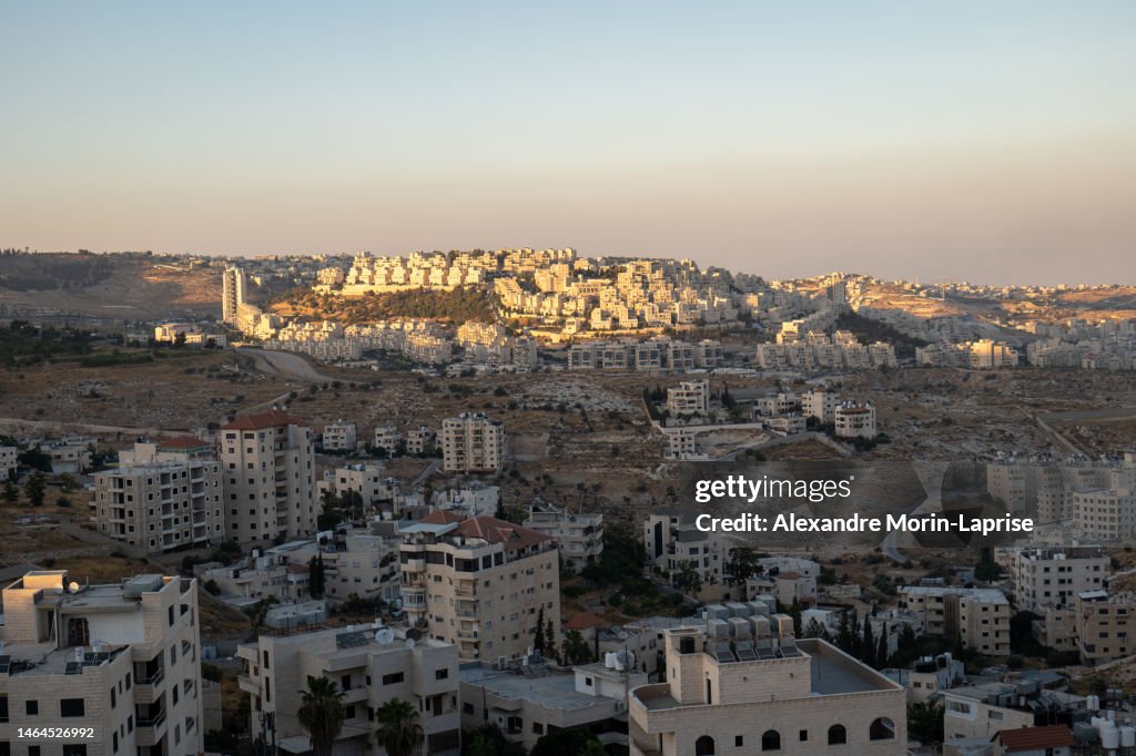 Bethlehem, West Bank, Palestine - 22 July 2022: Cityscape at Dusk with Last Sun Rays Over the White Stone Buildings