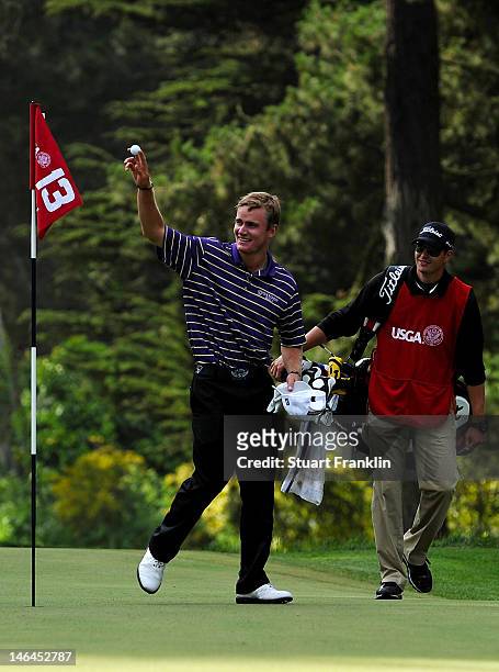 John Peterson of the United States celebrates a hole-in-one on the 13th hole with his caddie Gentry Mangun during the third round of the 112th U.S....