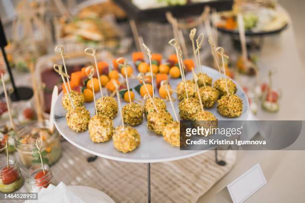 beautifully decorated catering banquet table with different food snacks and appetizers on corporate christmas birthday party event or wedding celebration - canapes stock pictures, royalty-free photos & images