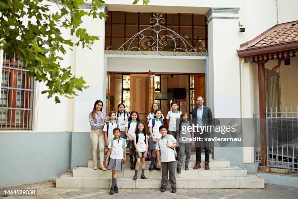 Organized group photo of educators and school children