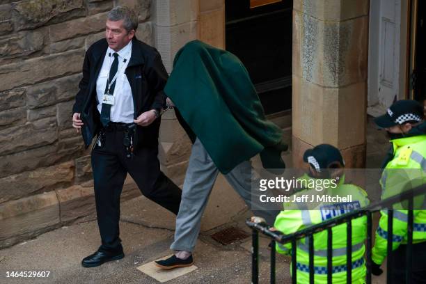 Andrew Miller is taken from Selkirk Sheriff covered by a blanket on February 09, 2023 in Selkirk, Scotland. Andrew Miller, 53 and locally known as...