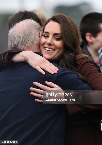 Catherine, Princess of Wales hugs her former school teacher Jim Embury during a visit to the National Maritime Museum Cornwall with Prince William,...