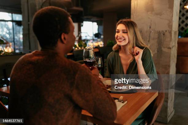happy woman on date with boyfriend. - couple dinner date stock pictures, royalty-free photos & images