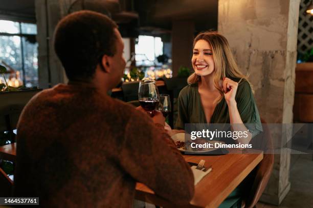 happy woman on date with boyfriend. - restaurant dinner stock pictures, royalty-free photos & images